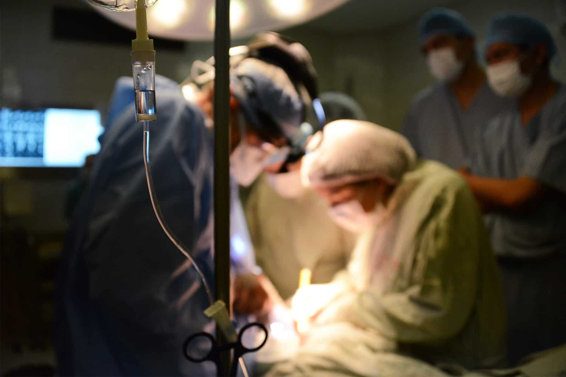 2015 Medical Outreach Trip in Bolivia. Doctors performing surgery on a patient.